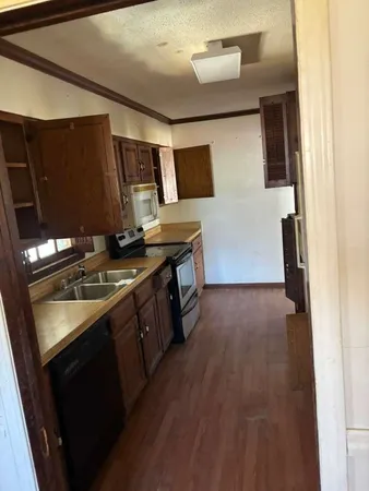 a kitchen with stainless steel appliances granite countertop a stove and a sink