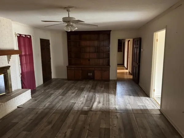 a view of walk in closet with clothes and a window