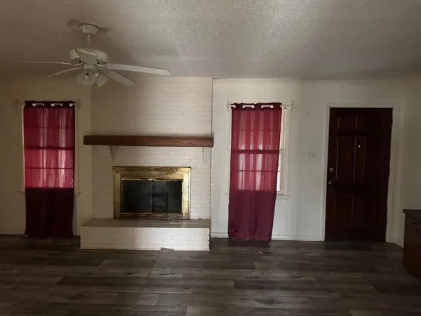 a view of a livingroom with furniture and a fireplace