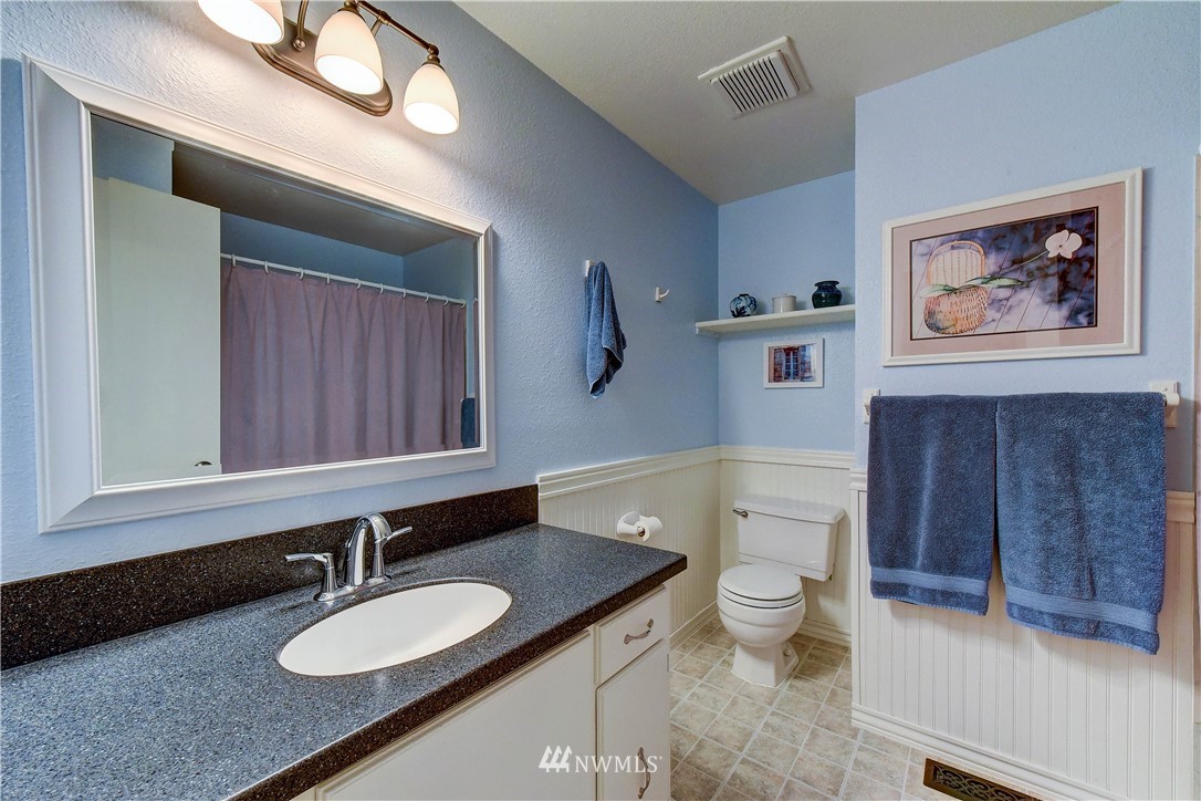 21616 9th Avenue West Bothell, WA 98021 - Photo 12 of 21 a bathroom with a granite countertop sink toilet and a mirror