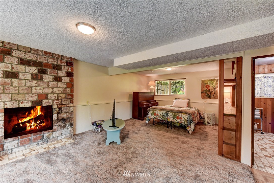 21616 9th Avenue West Bothell, WA 98021 - Photo 13 of 21 a bedroom with a bed and a fireplace