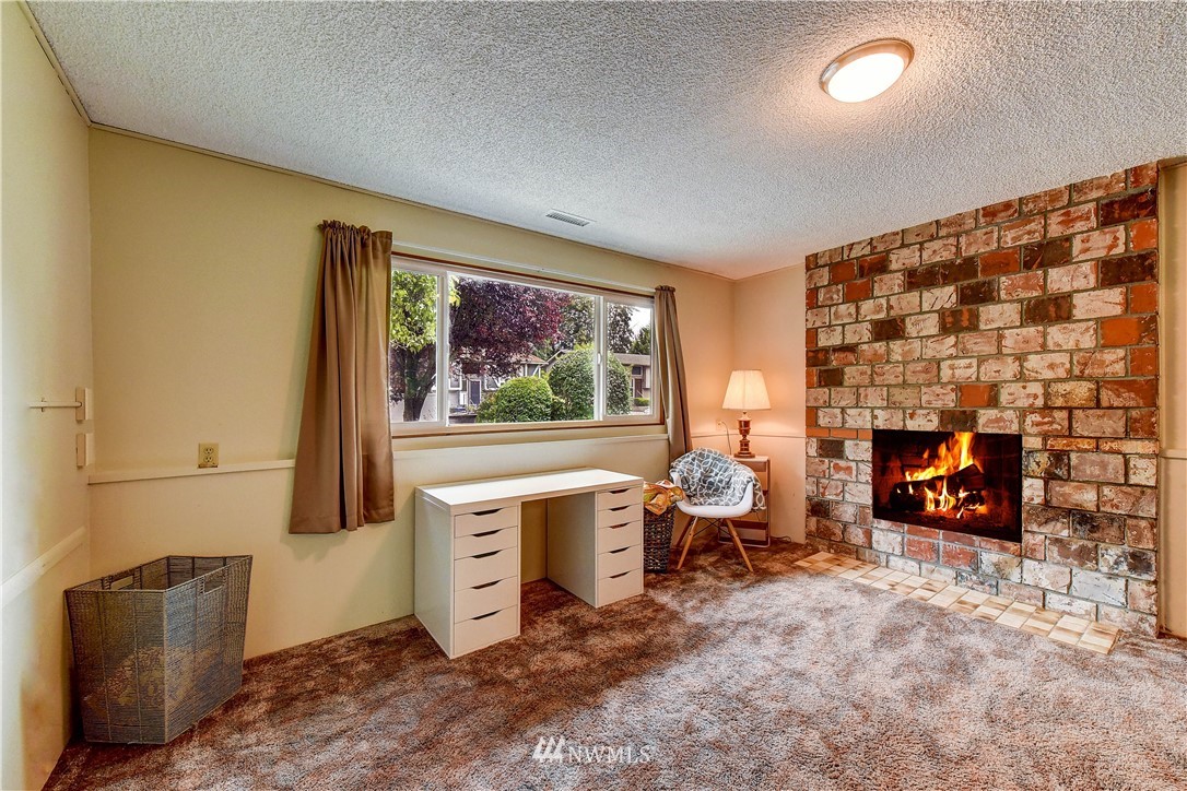 21616 9th Avenue West Bothell, WA 98021 - Photo 14 of 21 a living room with furniture a fireplace and a flat screen tv