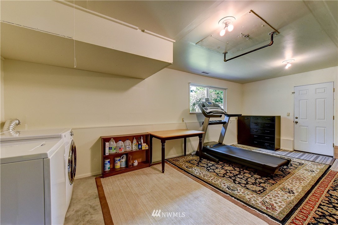 21616 9th Avenue West Bothell, WA 98021 - Photo 16 of 21 a living room with furniture flat screen tv and a fireplace