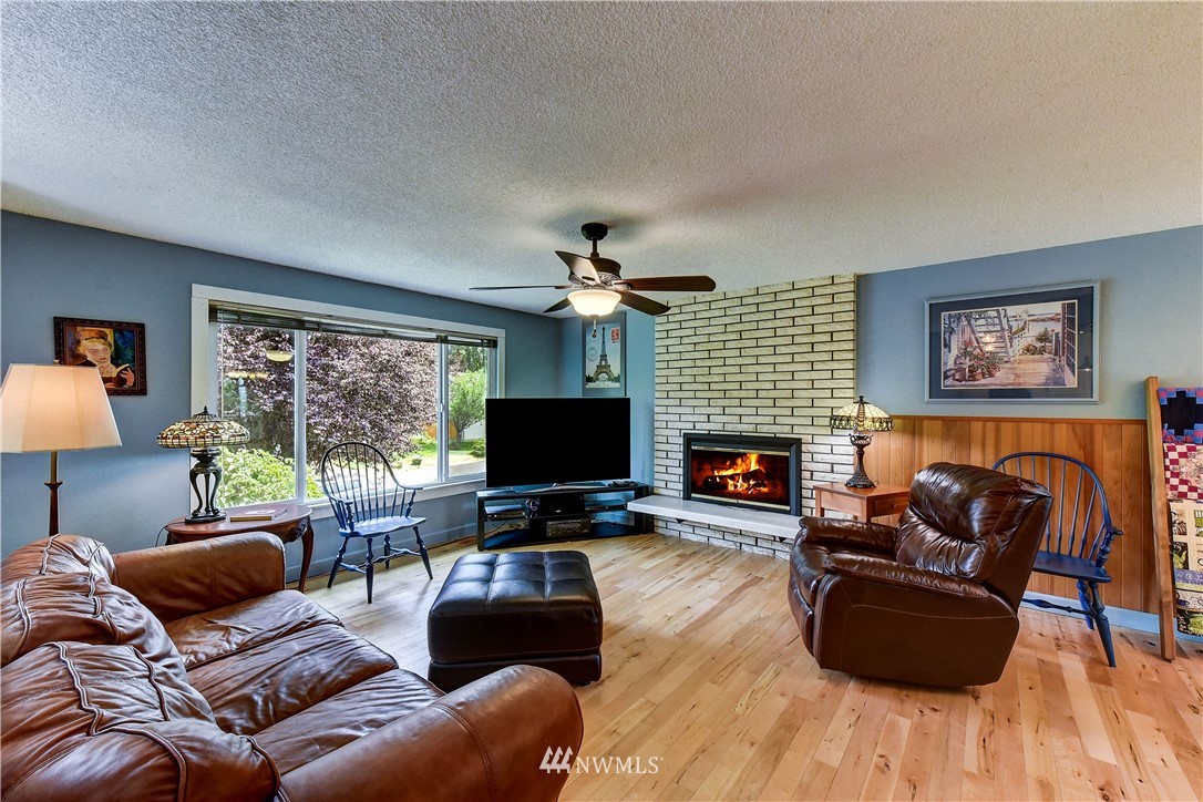 21616 9th Avenue West Bothell, WA 98021 - Photo 3 of 21 a living room with furniture a flat screen tv and a fireplace