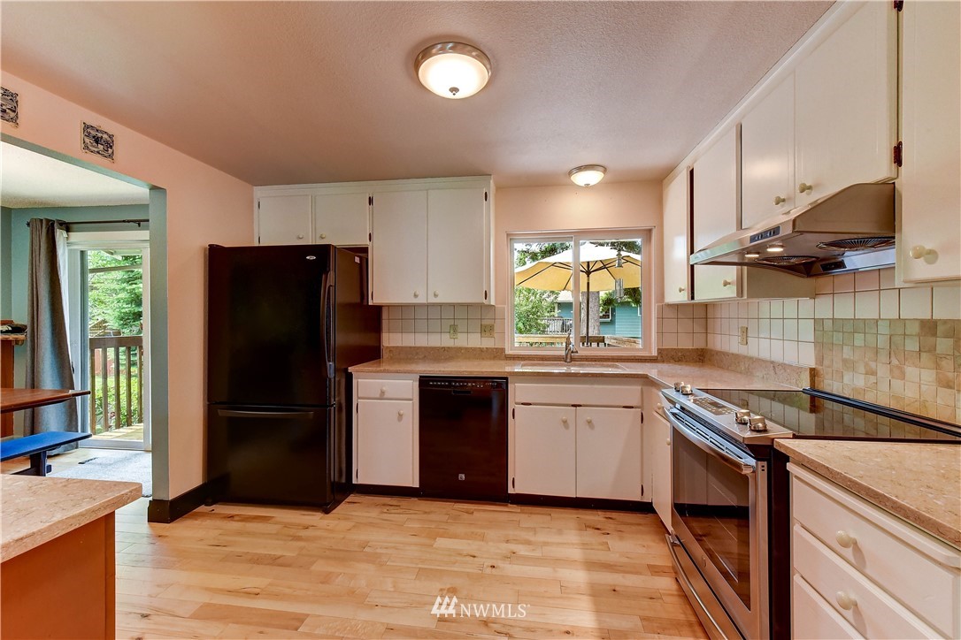 21616 9th Avenue West Bothell, WA 98021 - Photo 6 of 21 a kitchen with granite countertop a refrigerator stove and sink