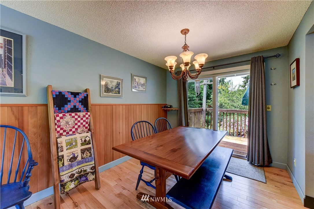 21616 9th Avenue West Bothell, WA 98021 - Photo 7 of 21 a view of a dining room with furniture wooden floor and chandelier