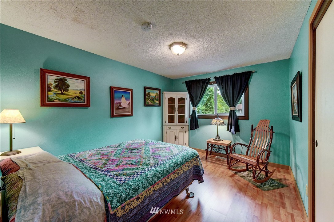21616 9th Avenue West Bothell, WA 98021 - Photo 10 of 21 a bedroom with a bed painting on wall and a large window