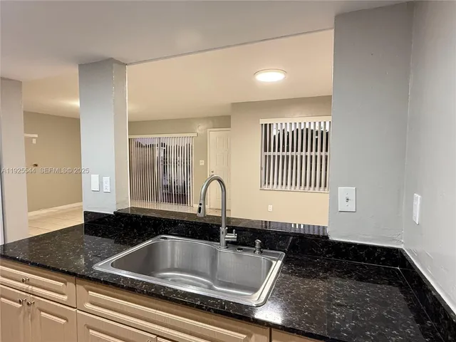 a kitchen with granite countertop a sink and a granite counter tops