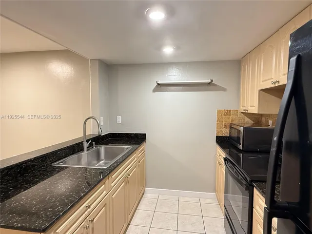 a kitchen with a sink and washing machine