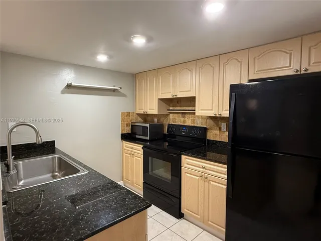a kitchen with a refrigerator sink and stove