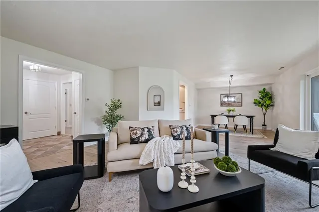 a living room with furniture potted plant and a window