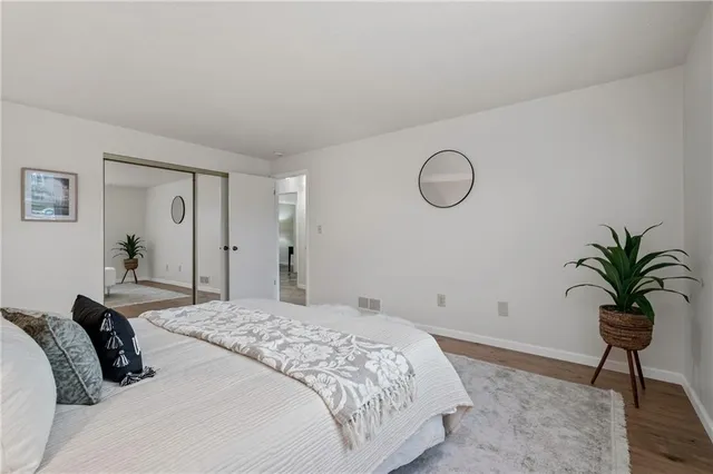 a bedroom with a bed and a potted plant