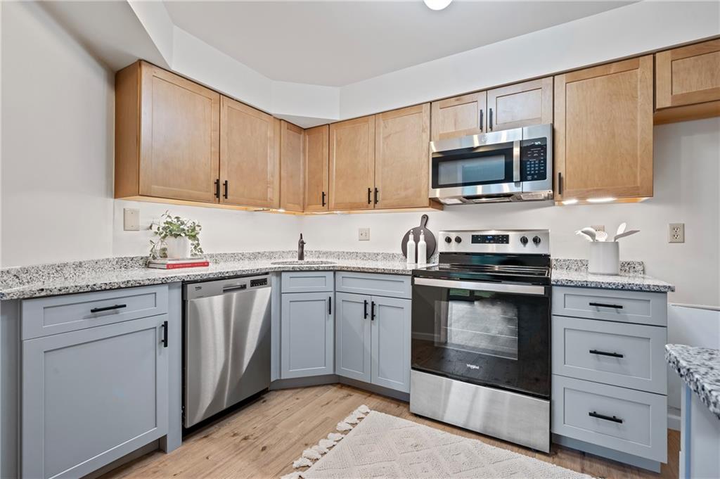 31 Huston Road Oakmont, PA 15139 - Photo 7 of 38 a kitchen with stainless steel appliances granite countertop a stove microwave and sink