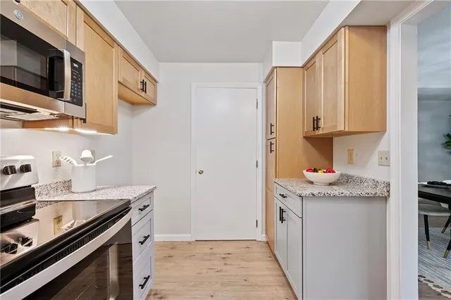 a kitchen with stainless steel appliances granite countertop a sink and a stove