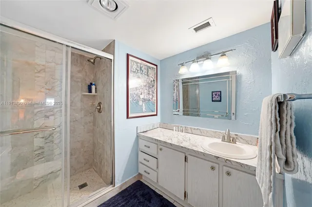 a bathroom with a toilet sink vanity tub and mirror