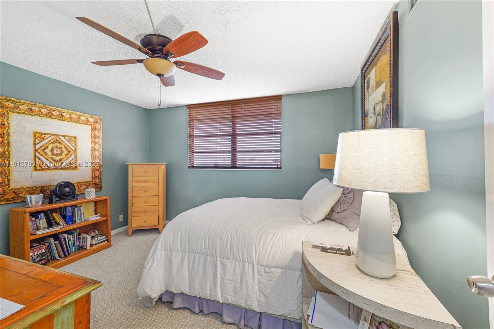 2430 DC Country Club Boulevard, Unit 6092 Deerfield Beach, FL 33442 - Photo 14 of 32 a bedroom with a bed and a lamp on table