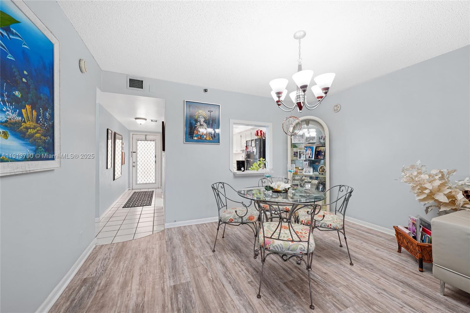 2430 DC Country Club Boulevard, Unit 6092 Deerfield Beach, FL 33442 - Photo 2 of 32 a view of a dining room with furniture and wooden floor