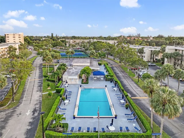 a view of a city with tall buildings and a big yard