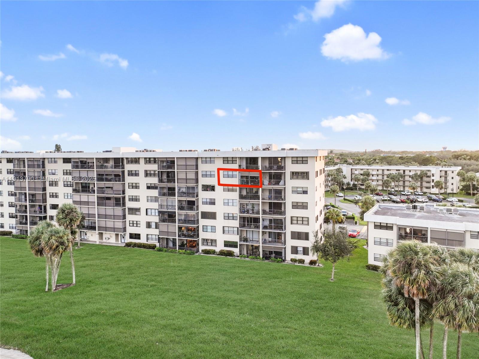 2430 DC Country Club Boulevard, Unit 6092 Deerfield Beach, FL 33442 - Photo 24 of 32 a view of a city with tall buildings and a big yard
