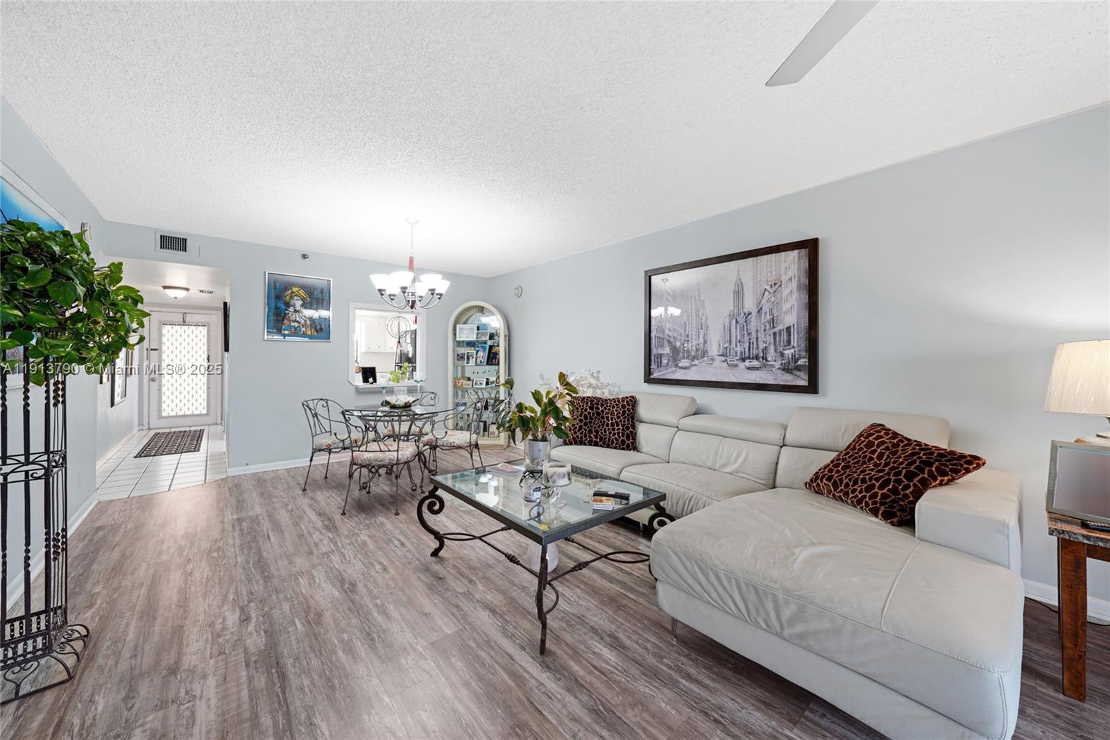 2430 DC Country Club Boulevard, Unit 6092 Deerfield Beach, FL 33442 - Photo 3 of 32 a living room with furniture and a potted plant