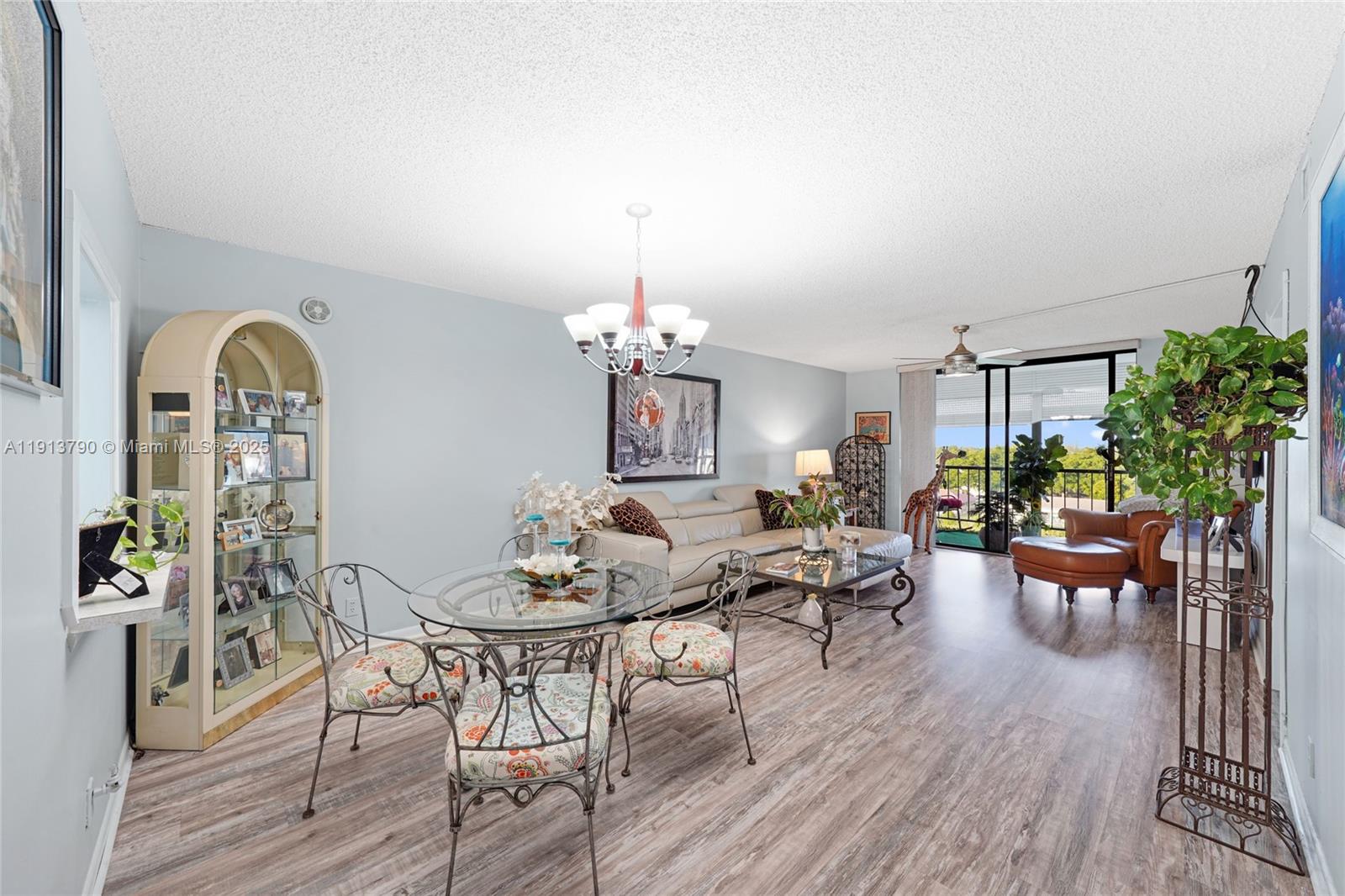 2430 DC Country Club Boulevard, Unit 6092 Deerfield Beach, FL 33442 - Photo 4 of 32 a view of a dining room with furniture and wooden floor