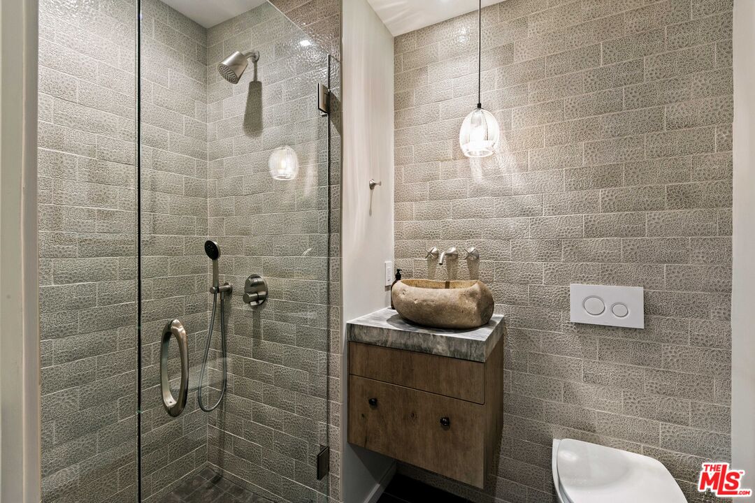 31558 Victoria Point Road Malibu, CA 90265 - Photo 42 of 55 a bathroom with a toilet a sink and shower