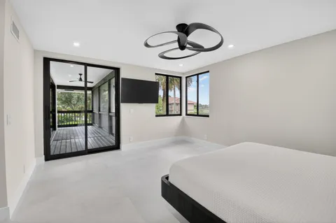 a bedroom with a bed and a flat tv screen