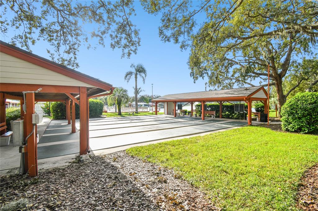 11340 Carriage Hill Drive, Unit 4 Port Richey, FL 34668 - Photo 28 of 36 a view of building with outdoor space
