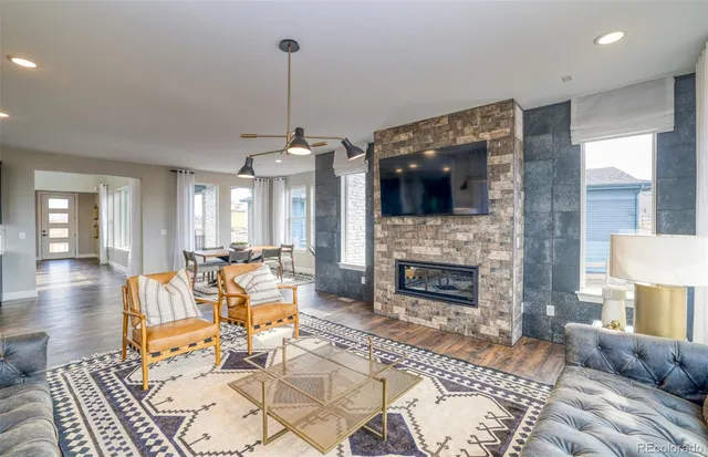 a living room with furniture a fireplace and a flat screen tv