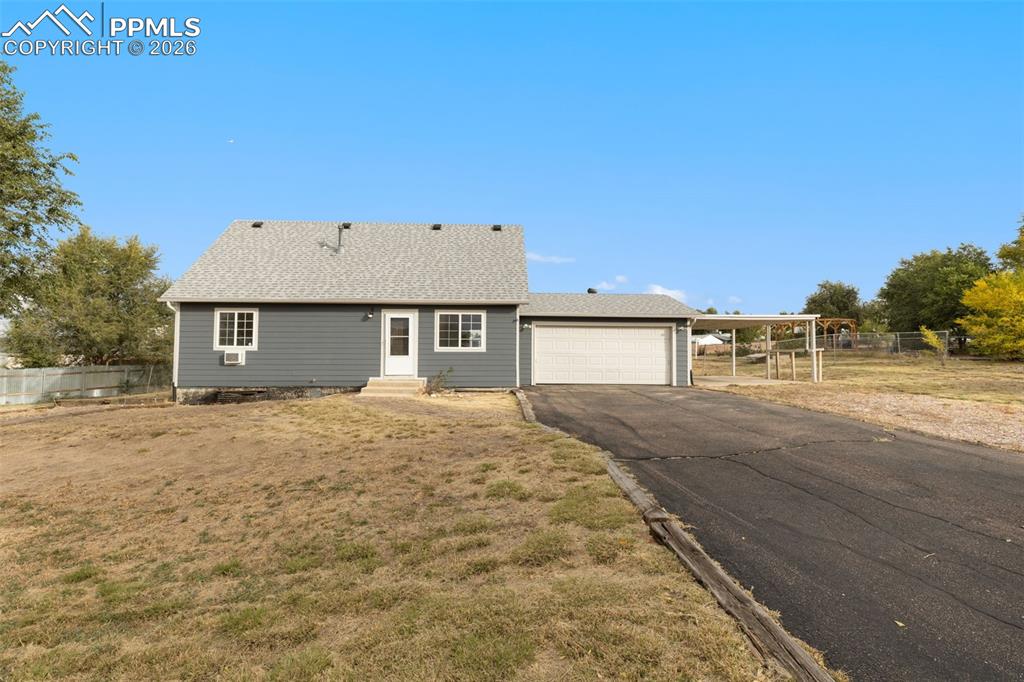 9430 Bar B Road Fountain, CO 80817 - Photo 11 of 43 a front view of a house with a yard