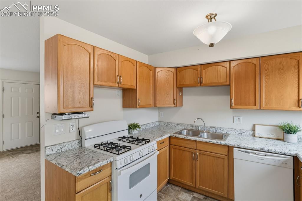 9430 Bar B Road Fountain, CO 80817 - Photo 17 of 43 a kitchen with stainless steel appliances granite countertop a stove a sink and a microwave