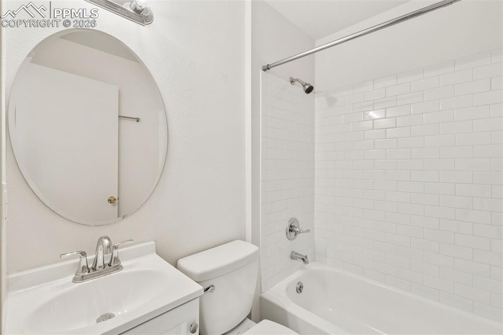 9430 Bar B Road Fountain, CO 80817 - Photo 24 of 43 a bathroom with a sink a toilet and a mirror