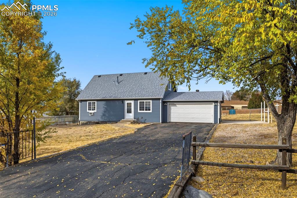 9430 Bar B Road Fountain, CO 80817 - Photo 7 of 43 a front view of a house with a yard