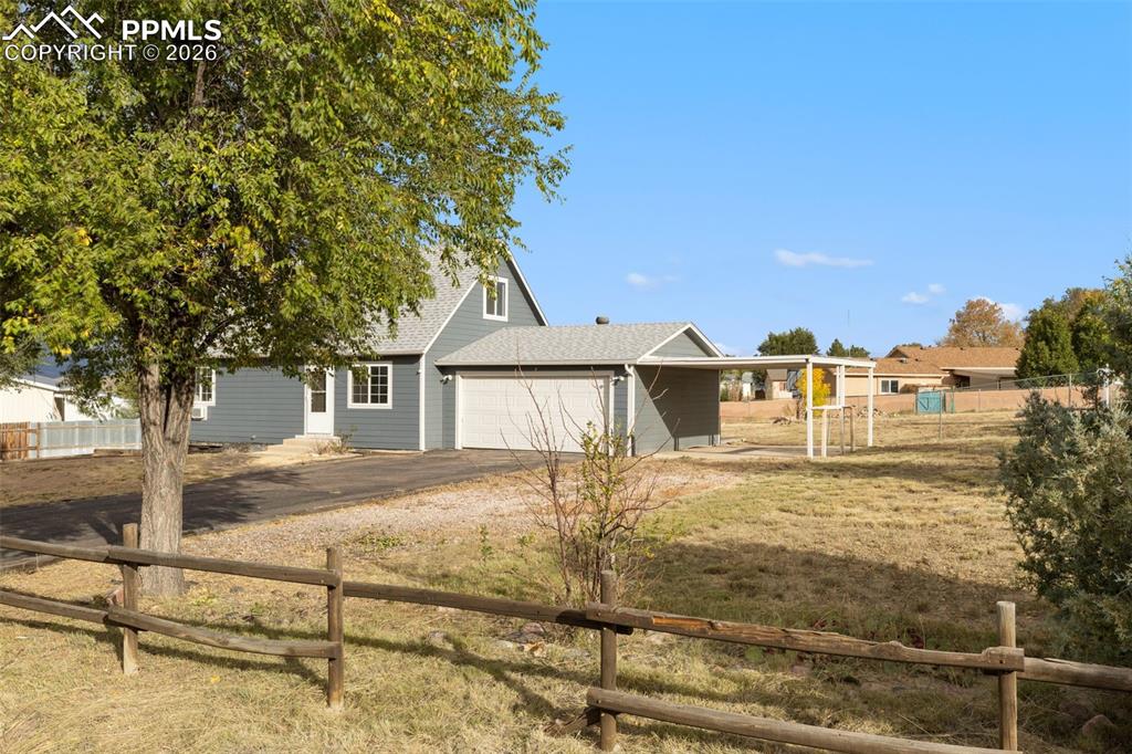 9430 Bar B Road Fountain, CO 80817 - Photo 10 of 43 a view of a house with a yard