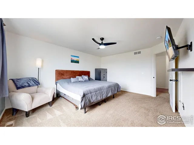 a bedroom with a bed and a couch