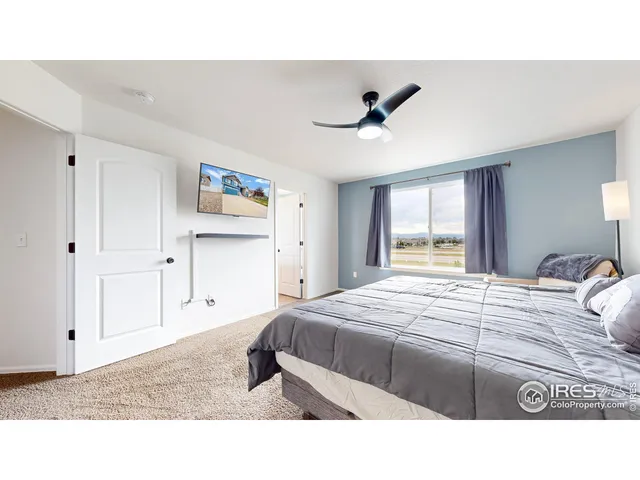 a bedroom with a bed a window and closet