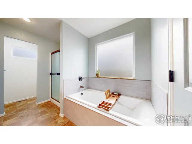 a bathroom with a tub sink and a mirror
