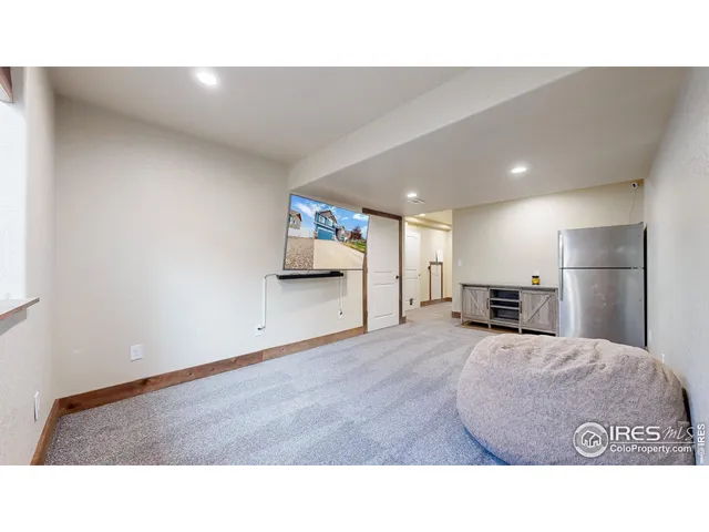a room with kitchen island sink and refrigerator