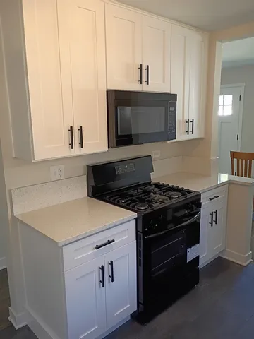 a kitchen with a stove and a microwave