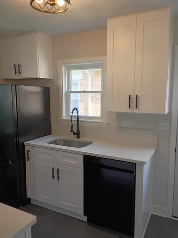 a kitchen with a sink and cabinets