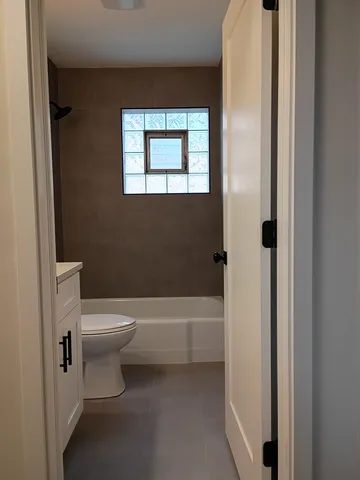a bathroom with a toilet and a bathtub