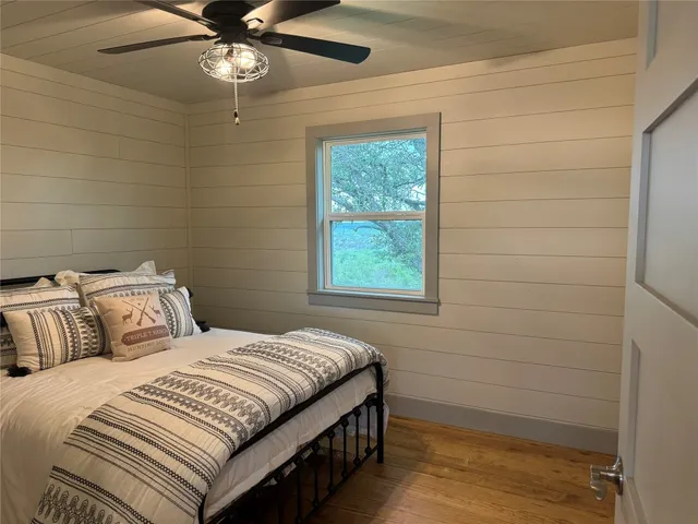 a bedroom with a large bed and a window