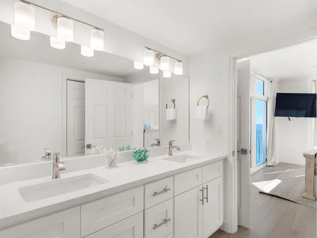 a bathroom with a double vanity sink mirror and double