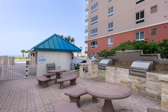a view of a patio with table and chairs with wooden fence