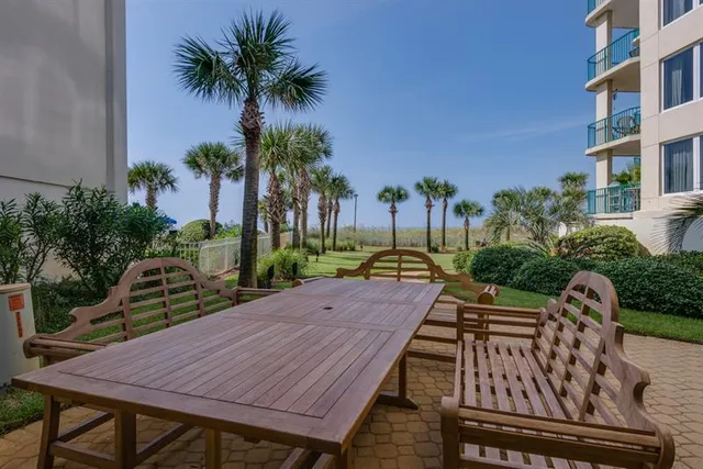 a view of a wooden dinning tables and chairs in patio
