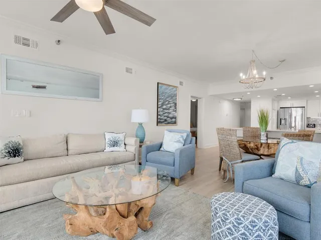 a living room with furniture and a chandelier