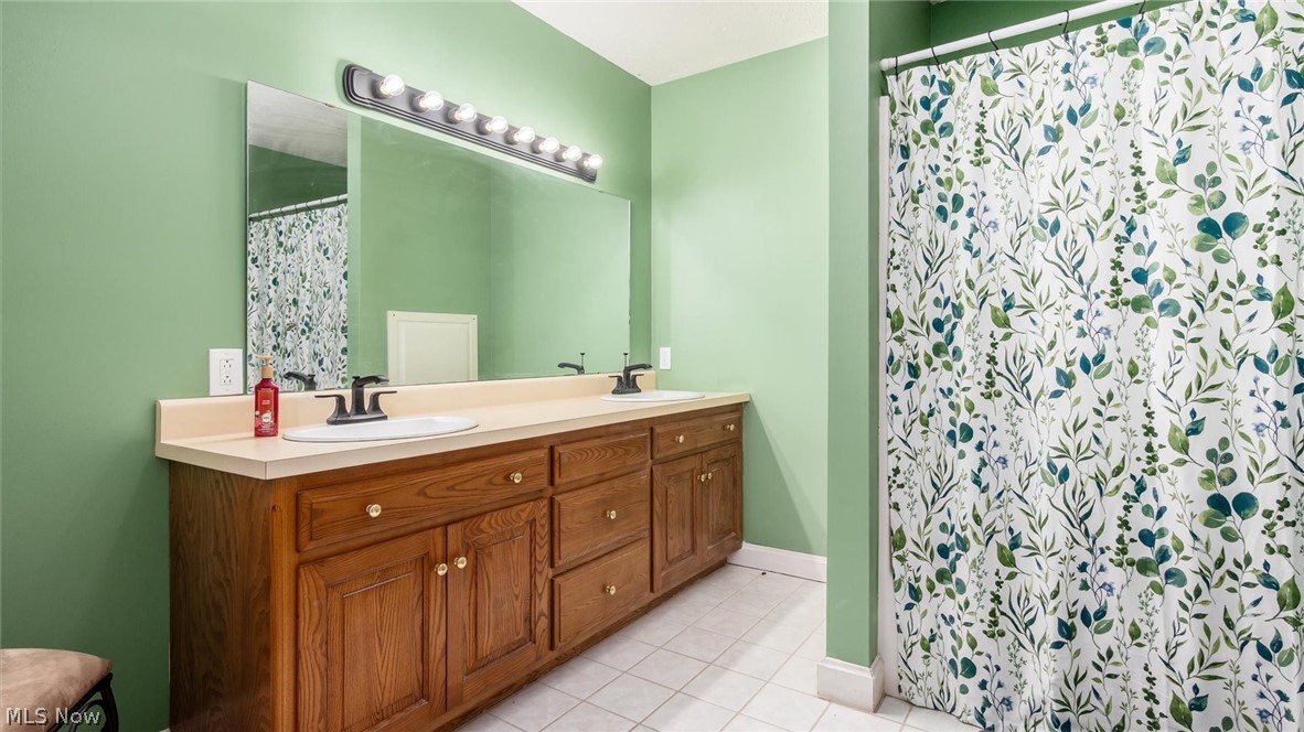 2531 Nicholas Lane Dresden, OH 43821 - Photo 25 of 40 Full bathroom with double vanity, a shower with curtain, and light tile patterned flooring