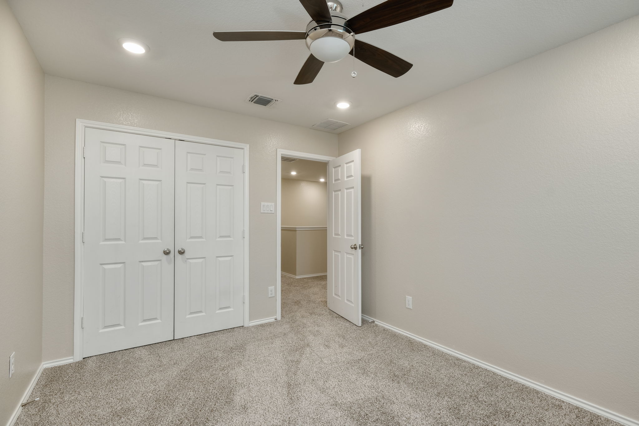 2017 Rhett's Place Leander, TX 78641 - Photo 11 of 13 Plush carpeting and recessed lighting create a comfortable atmosphere in this versatile bedroom space.