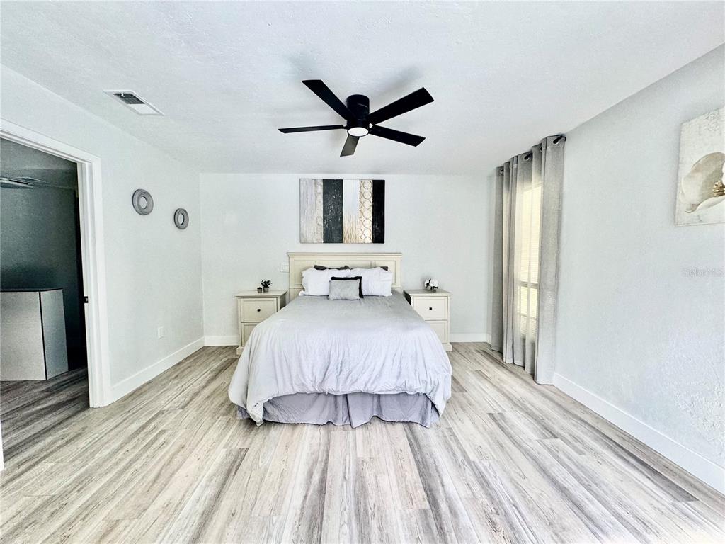 5407 Southwest 82 Terrace Gainesville, FL 32608 - Photo 13 of 31 a bedroom with a bed and a chandelier