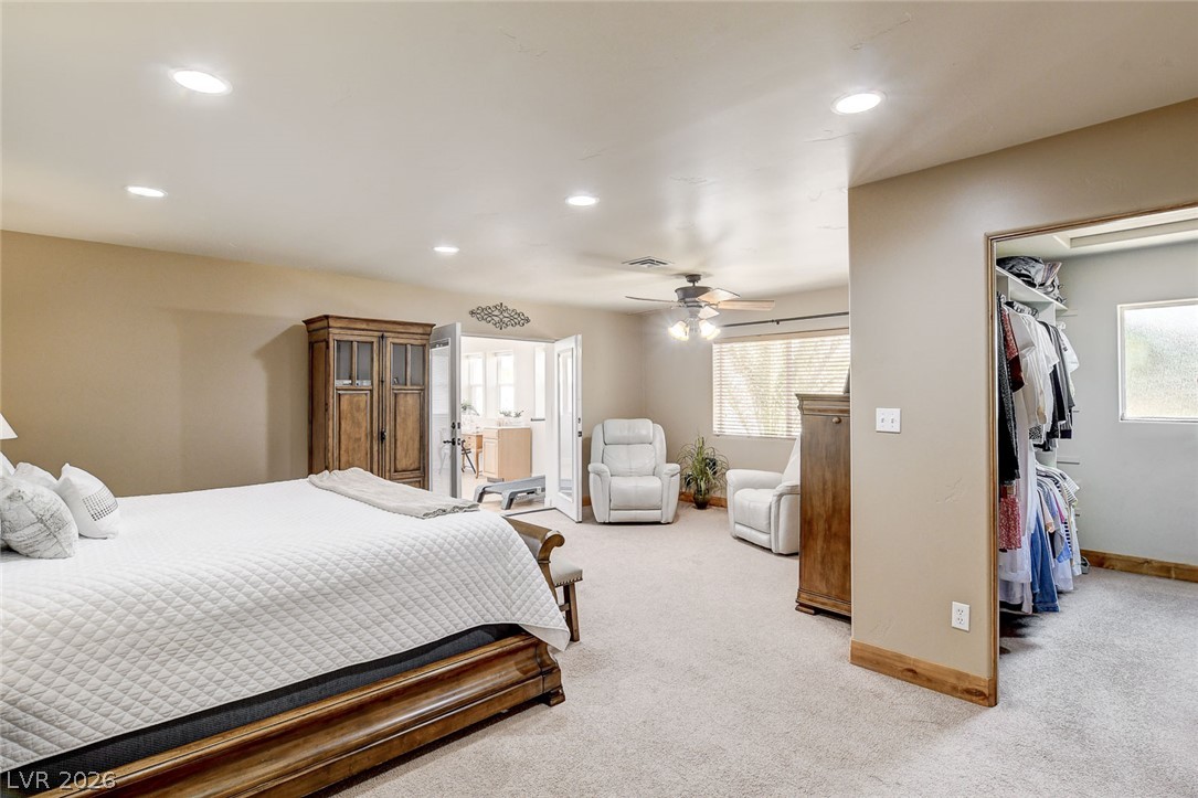 1950 Bowman Road Logandale, NV 89021 - Photo 30 of 81 A generously proportioned bedroom features plush carpeting and French doors leading to an adjoining Arizona room.